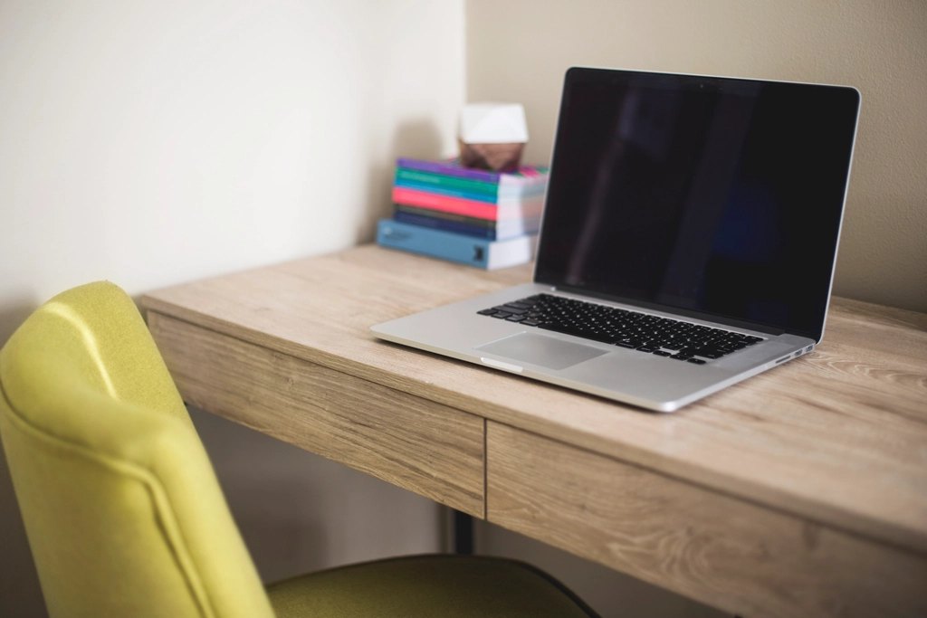 MacBook next stack books wooden